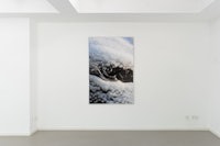 a white room with a painting on the wall