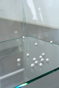 a glass table with a lot of pearls on it