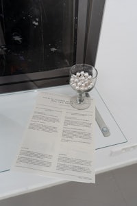 a bowl of pearls on a table next to a fireplace